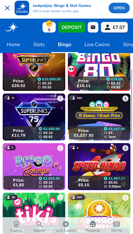 A Speed Bingo rocket and a musical Bingo Lounge sign among the room tiles, below a download banner for the Jackpotjoy app